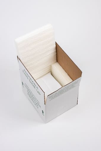 Green cell foam being used as cushioning in a cardboard box